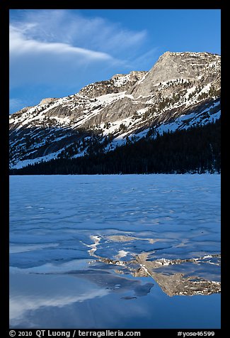 Peak reflected in thawing Tenaya Lake. Yosemite National Park, California, USA.