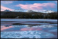 Peaks reflected in snow melt pool, Twolumne Meadows, sunset. Yosemite National Park, California, USA.