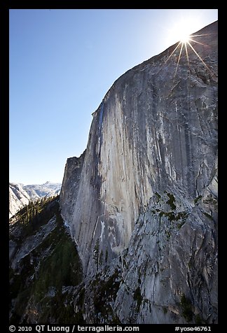 Sunburst at the top of Half-Dome face. Yosemite National Park, California, USA.