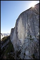 Sunburst at the top of Half-Dome face. Yosemite National Park, California, USA. (color)