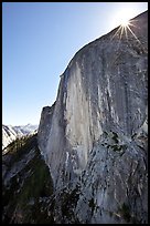 Sunburst at the top of Half-Dome face. Yosemite National Park, California, USA.