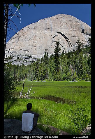 Hiker sitting at Lost Lake on west side Half-Dome. Yosemite National Park, California, USA.