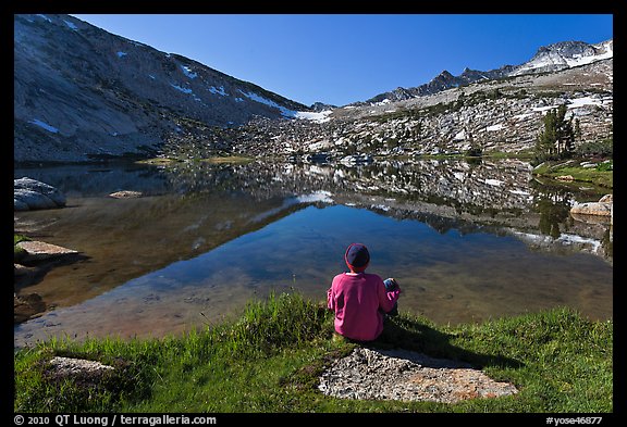 Hiker sitting by alpine lake, Vogelsang. Yosemite National Park (color)