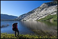 Park visitor with backpack looking, Merced Lake, morning. Yosemite National Park ( color)
