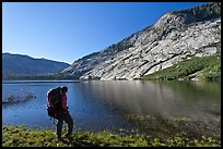 Park visitor with backpack looking, Merced Lake, morning. Yosemite National Park, California, USA. (color)