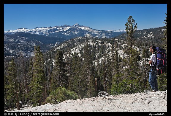 Backpacker surveying high country from Cathedral Pass. Yosemite National Park (color)