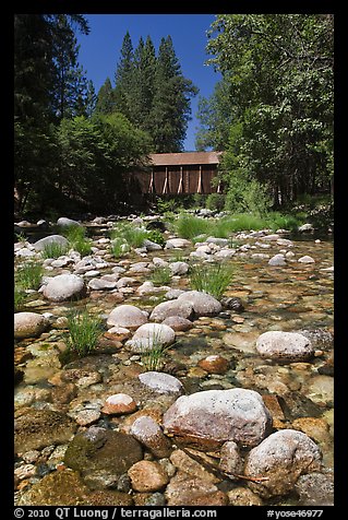 Pebbles in river and covered bridge, Wawona. Yosemite National Park, California, USA.