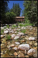 Pebbles in river and covered bridge, Wawona. Yosemite National Park, California, USA.