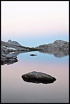 Stone in Roosevelt Lake, dawn. Yosemite National Park, California, USA.