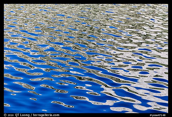 Lit mountain reflected in ripples, Roosevelt Lake. Yosemite National Park, California, USA.