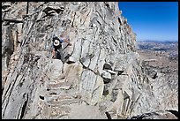 Hiker on summit block of Mount Conness. Yosemite National Park, California, USA.