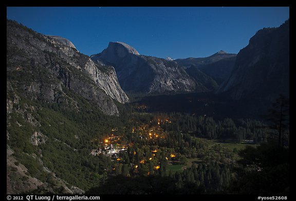 Yosemite Village lights and Half-Dome by moonlight. Yosemite National Park, California, USA.