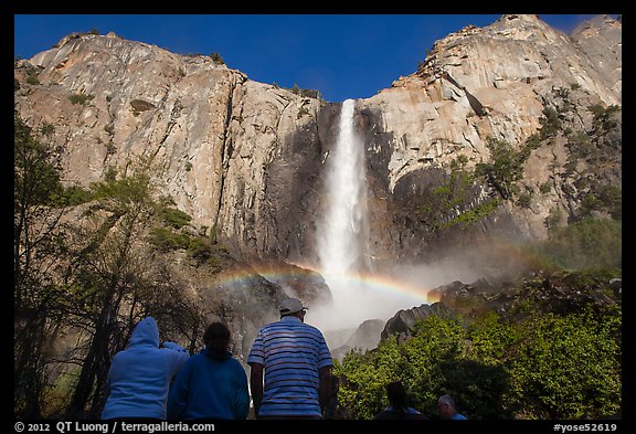 Tourists looking at Bridalvail Fall rainbow. Yosemite National Park, California, USA.