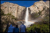 Tourists looking at Bridalvail Fall rainbow. Yosemite National Park, California, USA.