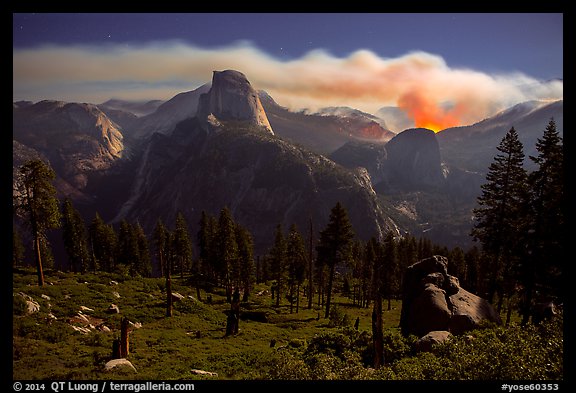 Half-Dome and plume of smoke from wildfire at night. Yosemite National Park, California, USA.