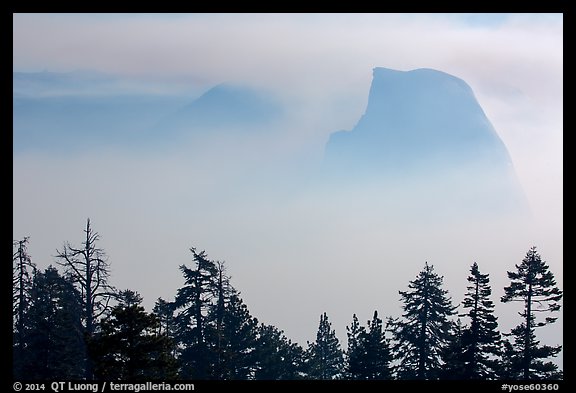 Half-Dome and Clouds Rest emerging from smoke. Yosemite National Park, California, USA.