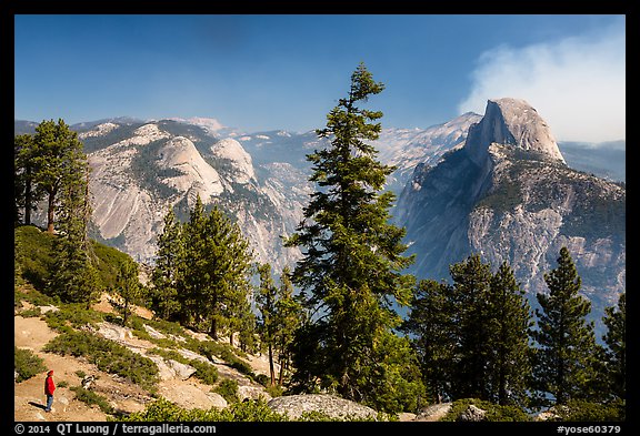 Visitor looking, Half-Dome from Glacier Point. Yosemite National Park, California, USA.