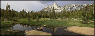 Stream and Cathedral Peak in storm light. Yosemite National Park, California, USA.