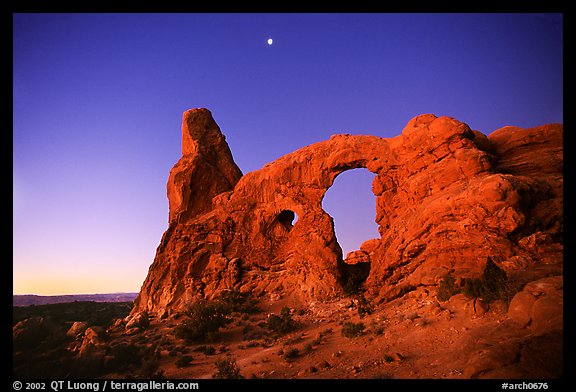 Turret Arch and moon, dawn. Arches National Park, Utah, USA.