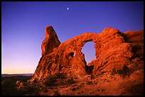 Turret Arch and moon, dawn. Arches National Park, Utah, USA. (color)