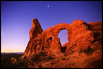 Turret Arch and moon, dawn. Arches National Park, Utah, USA.