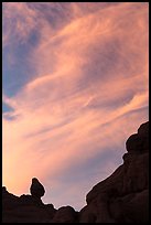 Sunset clouds and small balanced rock. Arches National Park, Utah, USA. (color)