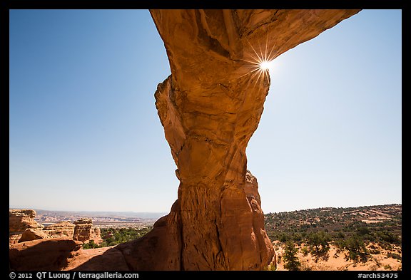 Broken Arch seen from below with sunburst at the crack. Arches National Park, Utah, USA.
