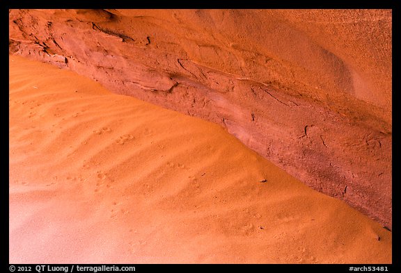 Sand ripples near wall with animal tracks. Arches National Park, Utah, USA.