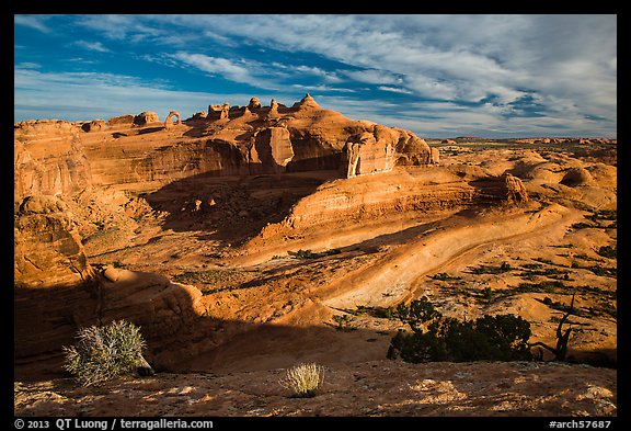 Entrada Sandstone basin with Delicate Arch in distance. Arches National Park, Utah, USA.