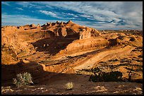 Entrada Sandstone basin with Delicate Arch in distance. Arches National Park, Utah, USA. (color)