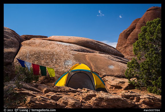 Tent with prayer flags amongst sandstone rocks. Arches National Park (color)