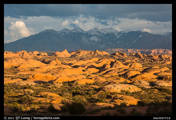 Petrified dunes and cloudy La Sal mountains. Arches National Park, Utah, USA.