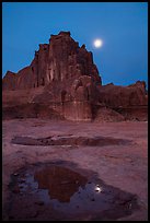 Courthouse tower and moon at night. Arches National Park, Utah, USA. (color)