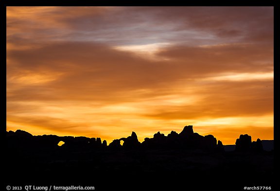 Windows and Turret Arch silhouetted at sunrise. Arches National Park, Utah, USA.