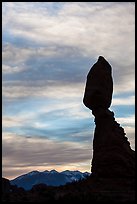 Balanced Rock silhouetted against La Sal Mountains and sky. Arches National Park, Utah, USA. (color)