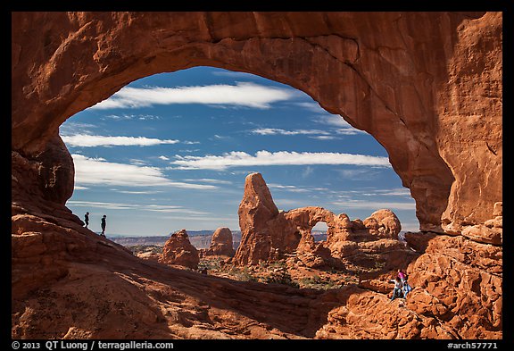 Family in the North Window span. Arches National Park, Utah, USA.