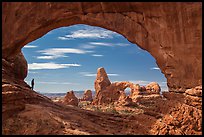 Park visitor looking, Turret Arch framed by North Window. Arches National Park, Utah, USA.