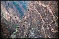 Sheer cliff with flourishes of crystalline pegmatite. Black Canyon of the Gunnison National Park, Colorado, USA.