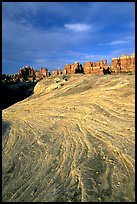 Sandstone striations and Needles near Elephant Hill, sunrise. Canyonlands National Park, Utah, USA.