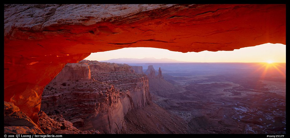 Sunrise and canyon landscape through Mesa Arch. Canyonlands National Park, Utah, USA.