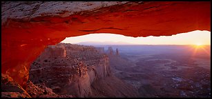 Sunrise and canyon landscape through Mesa Arch. Canyonlands National Park, Utah, USA.