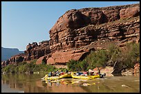 Rafts motoring upstream Colorado River. Canyonlands National Park, Utah, USA.