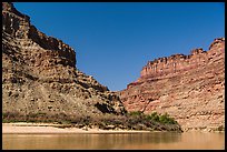 Cliffs towering above Confluence of Green and Colorado Rivers. Canyonlands National Park, Utah, USA.