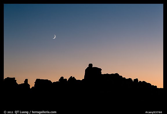 Crescent moon at sunset and Doll House spires. Canyonlands National Park (color)