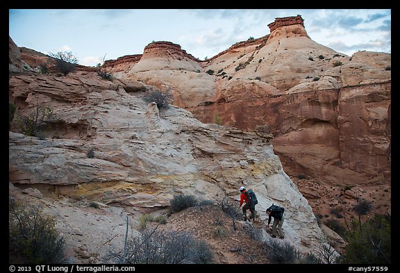 Hikers climbing out of High Spur slot canyon, Orange Cliffs Unit, Glen Canyon National Recreation Area, Utah. USA (color)