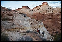 Hikers climbing out of High Spur slot canyon, Orange Cliffs Unit, Glen Canyon National Recreation Area, Utah. USA (color)