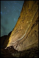 Illuminated canyon wall with rock art under starry sky, Horseshoe Canyon. Canyonlands National Park, Utah, USA.