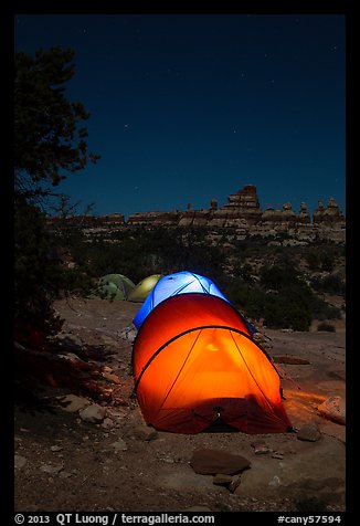 Lit tents at night in the Dollhouse. Canyonlands National Park, Utah, USA.