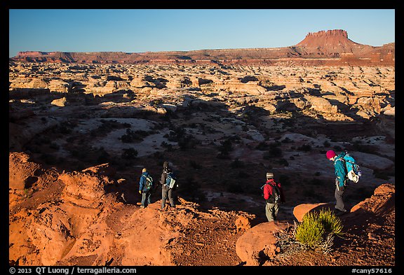 Hikers on Petes Mesa ridge above the Maze. Canyonlands National Park, Utah, USA.