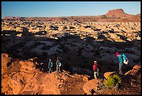 Hikers on Petes Mesa ridge above the Maze. Canyonlands National Park, Utah, USA.